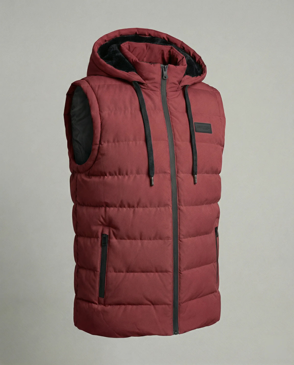 Close-up angle of a quilted hooded gilet showing the horizontal channel quilting and zip pocket detail