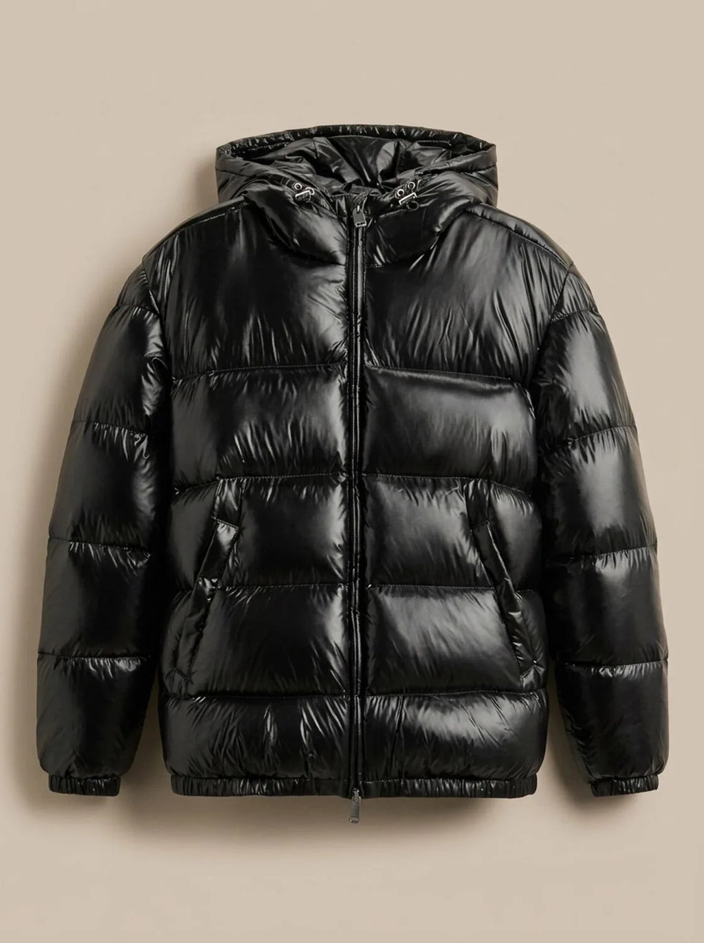 Detail shot of the silver zip pull and elasticated cuff on the hooded puffer jacket