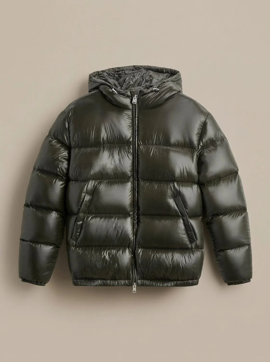 Flat lay of the glossy olive green puffer jacket with hood, zip and side pockets clearly visible