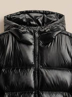 Close-up of the black jacket's hood and collar area showing the zip pull and adjustable hood toggles