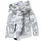 White and grey geometric print hooded jacket with drawstring hood and zipped side pocket close up