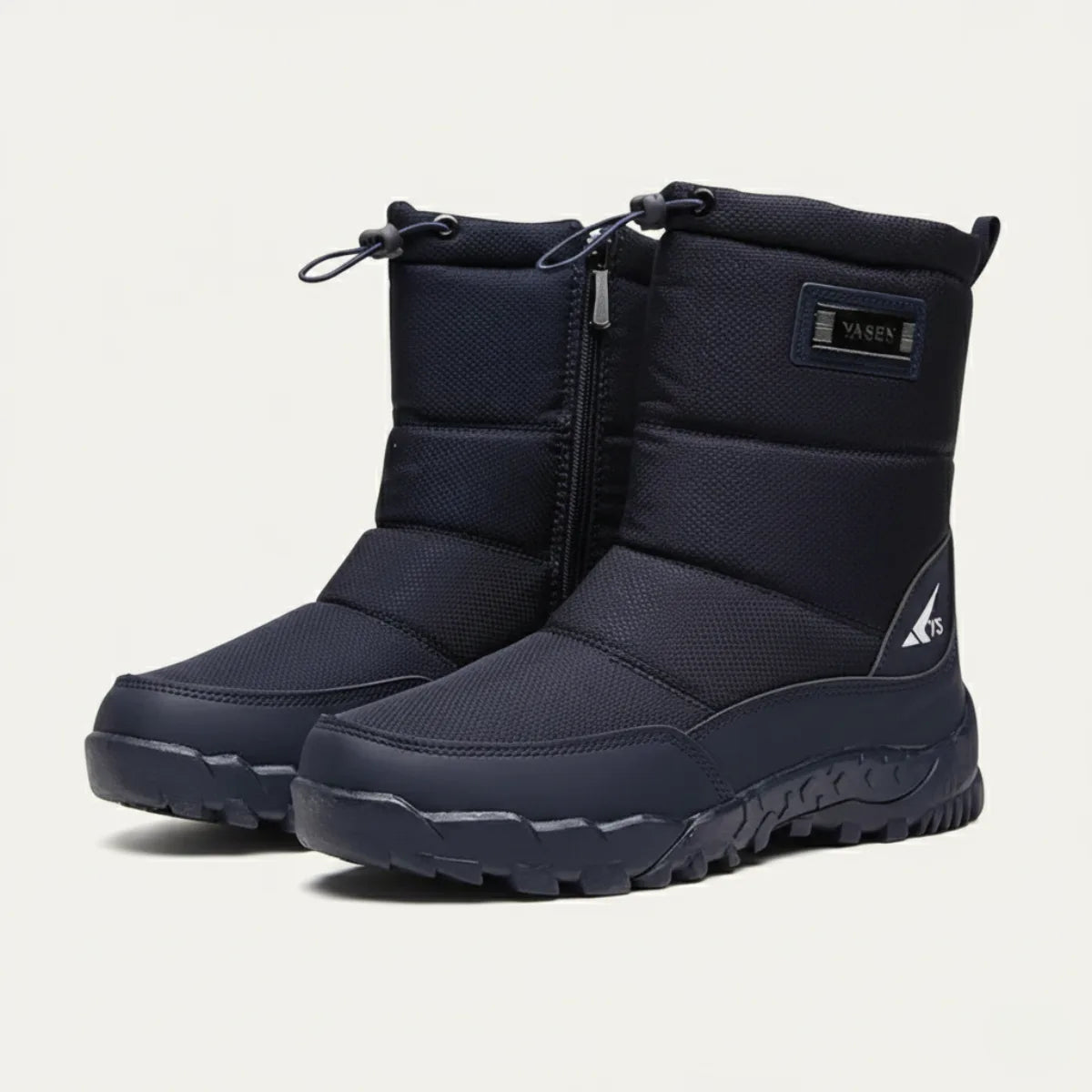 Side view of a pair of navy padded snow boots with zip closure, drawstring top and rugged tread sole