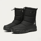 Three-quarter view of a pair of black padded snow boots with branded tab and chunky tread sole