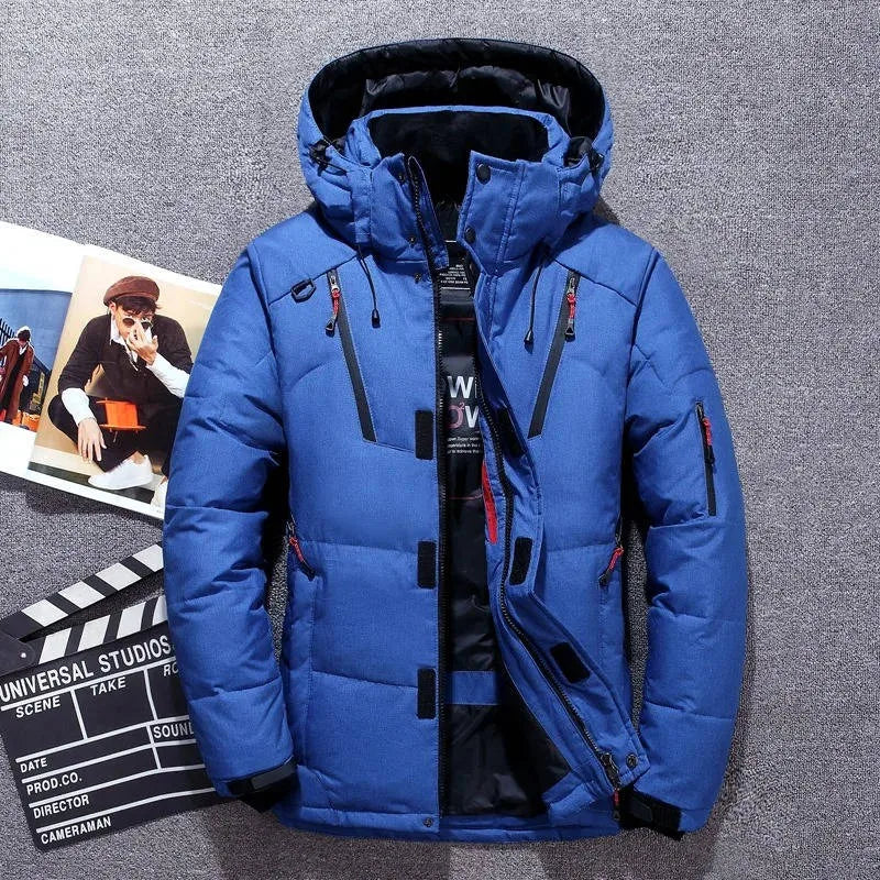 Blue padded winter parka with fur-lined hood laid flat, showing zip pockets and drawcord hem detail