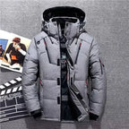 Grey quilted winter parka laid flat, showing stand collar, hood and dual zip chest pockets