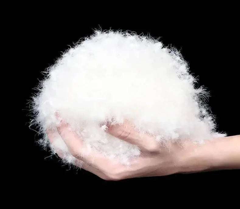 Magnified view of fine white down clusters, demonstrating the loft and softness of the fill material
