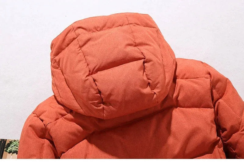 Close-up of the orange parka's detachable hood and stand collar with press-stud fastening