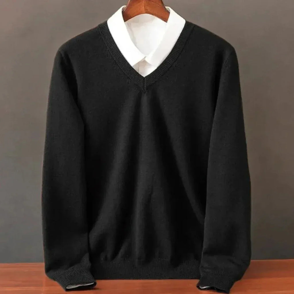 Black V-neck jumper layered over a white collared shirt, full front view showing ribbed cuffs and hem.