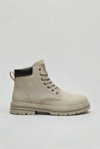 Side profile of a light grey lace-up ankle boot with a black heel panel and chunky lugged sole