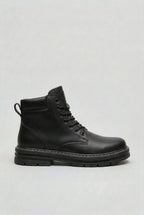 Side view of a black lace-up ankle boot with a thick ridged lug sole and contrast stitching