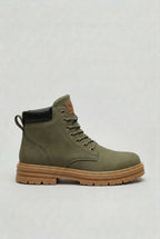 Side view of a dark green lace-up ankle boot with a black heel panel and tan sole unit