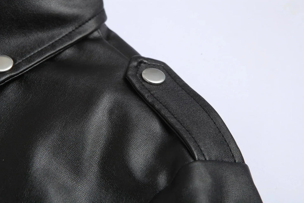 Close-up of the shoulder epaulette strap with press stud on the black leather jacket