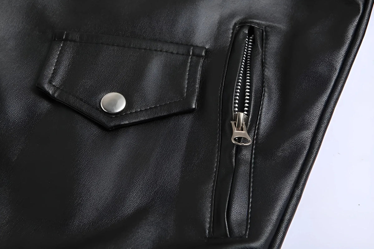 Close-up of the flap pocket and zip pocket detail on the black leather jacket