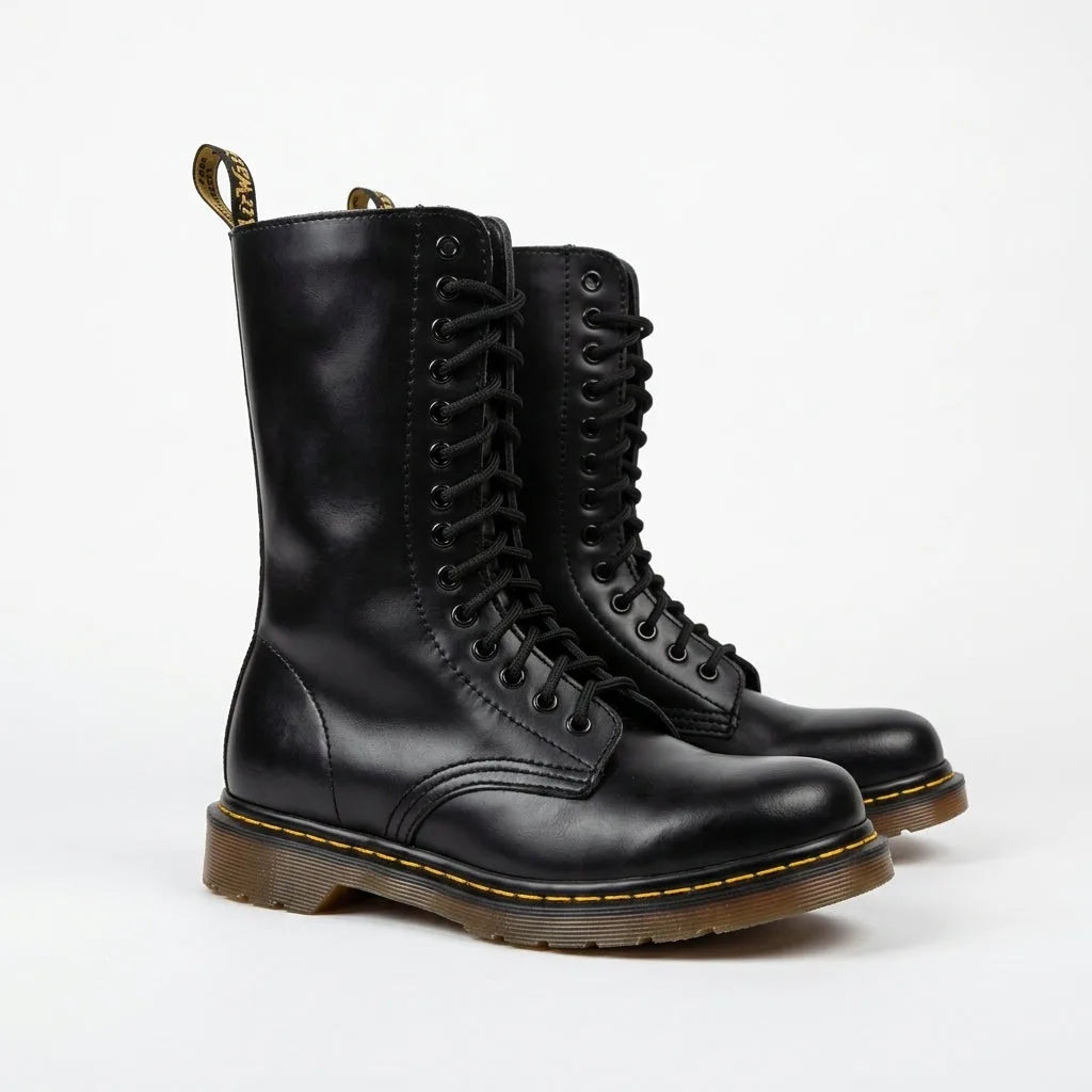 Pair of black leather combat boots with full lace-up front and ridged brown-tinted sole