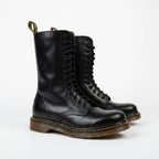 Pair of black leather combat boots with full lace-up front and ridged brown-tinted sole