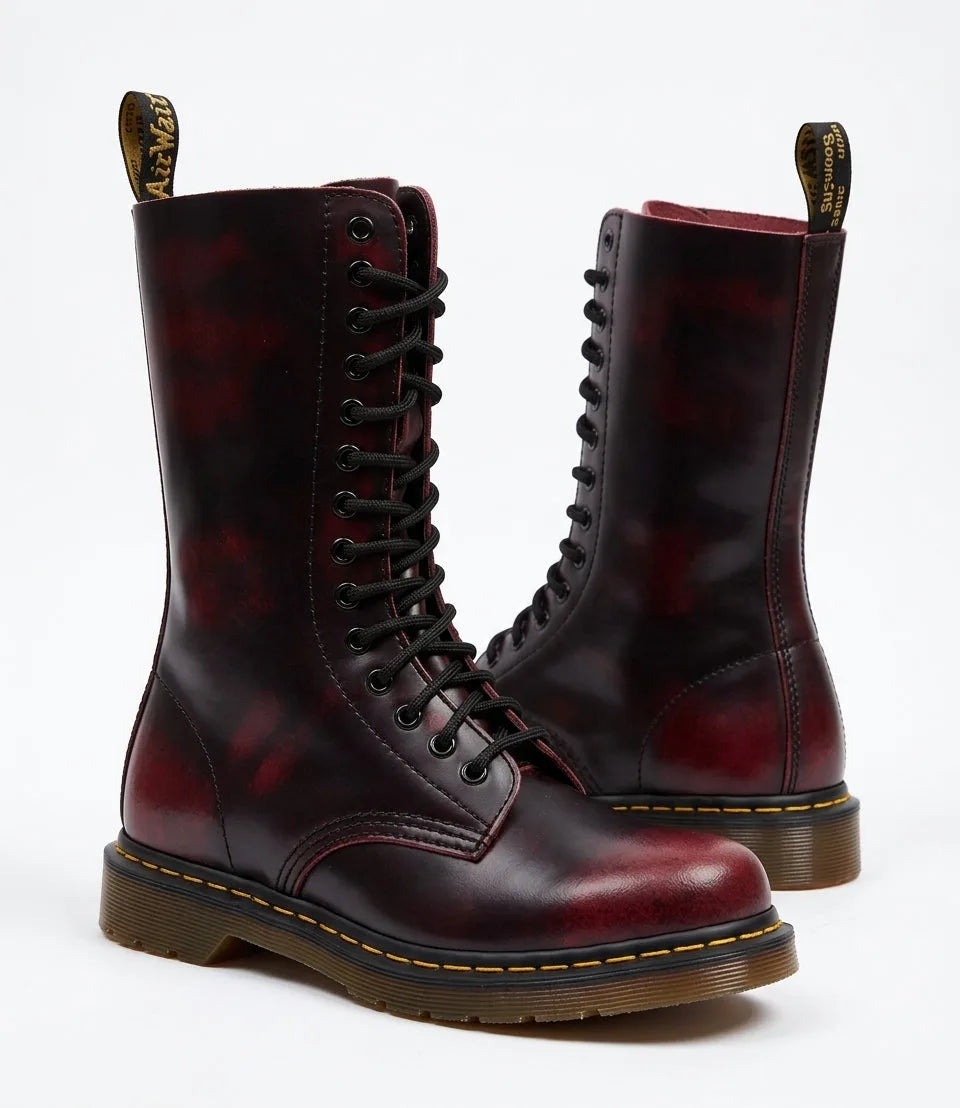 Pair of burgundy red leather combat boots with distressed finish and black laces