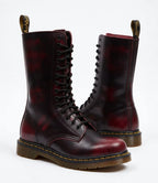 Pair of burgundy red leather combat boots with distressed finish and black laces