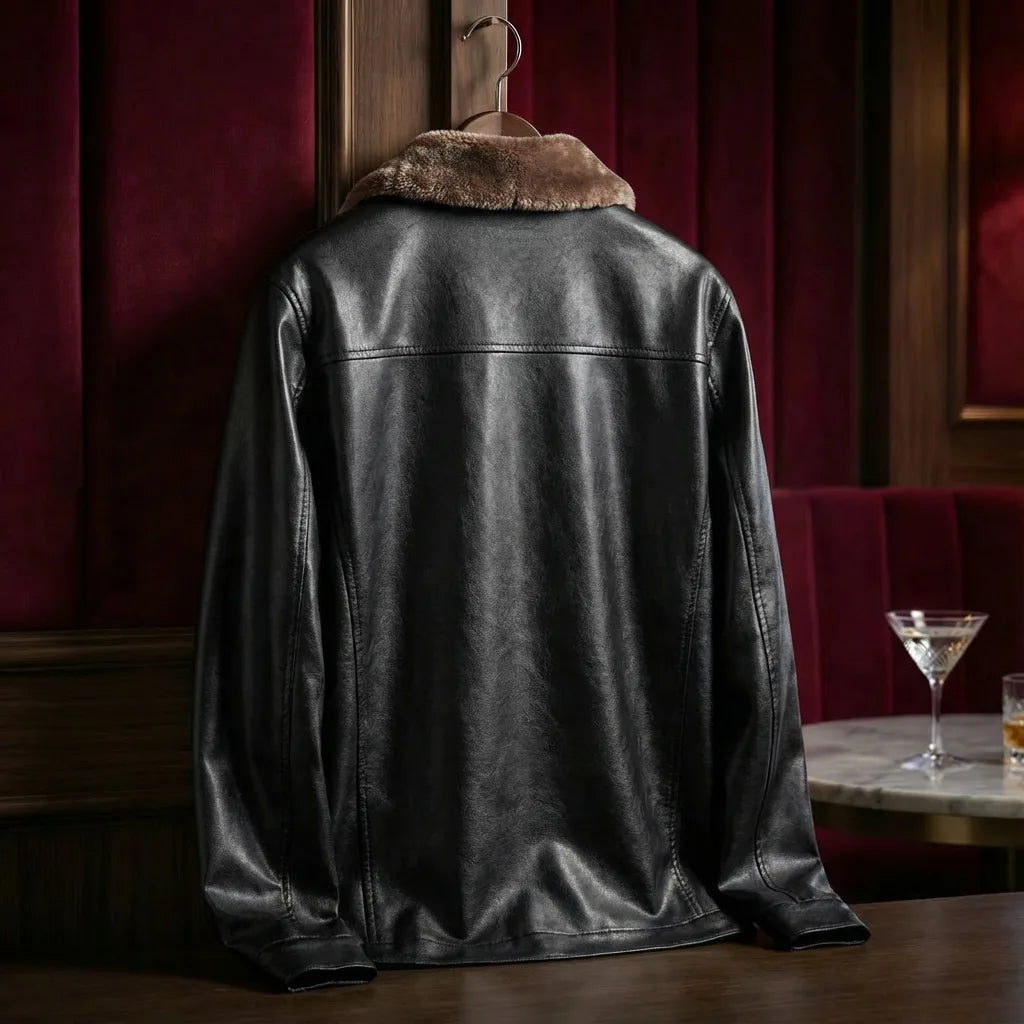 Back view of black shearling-collar leather jacket on a hanger, showing clean panel seams and smooth finish