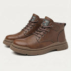 Side-by-side view of brown leather lace-up ankle boots with ridged sole and branded tongue tab