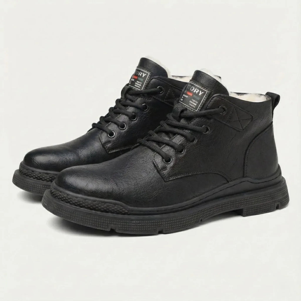 Pair of black leather lace-up ankle boots with ridged sole, shown together on display