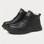 Pair of black leather lace-up ankle boots with ridged sole, shown together on display