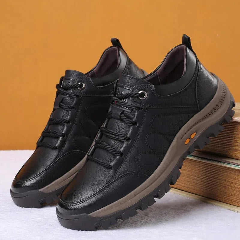 Front angled view of black leather shoe on white background with orange sole accents