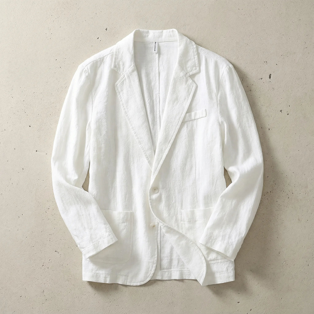 White textured linen blazer laid flat, showing notch lapel, chest welt pocket and patch pockets