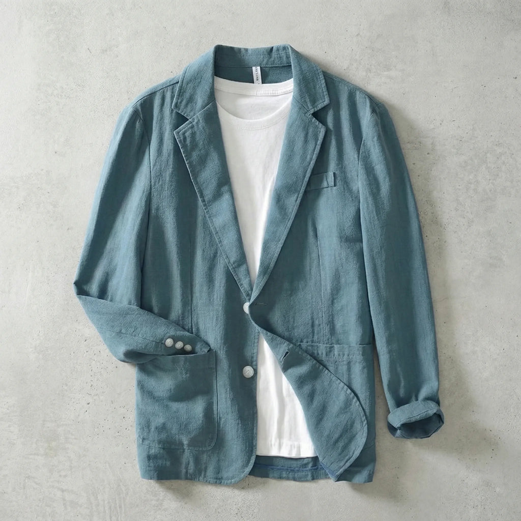 Teal linen blazer worn open over a white t-shirt, showing button cuffs and relaxed tailored fit