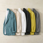 Six colourways of the linen blazer laid side by side in teal, beige, white, black, yellow and grey