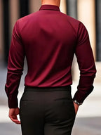 Dark brown shirt detail showing the sheen of the fabric and folded cuff near the wrist