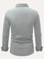 Light blue shirt detail showing the cuff and sleeve construction with a wristwatch visible