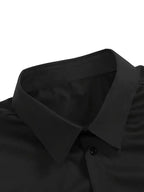 Grey long-sleeve dress shirt shown with hand in trouser pocket on an outdoor pathway