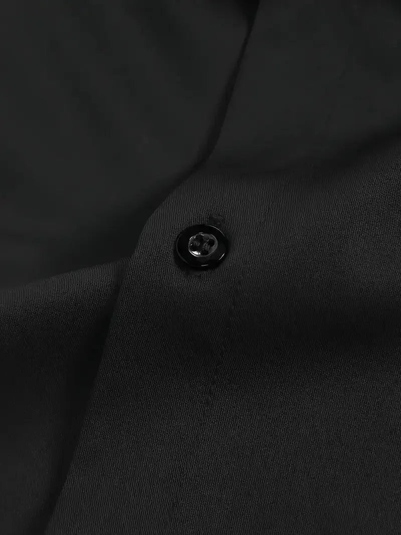 Dark grey button-down shirt shown with hand in pocket, highlighting the slim tailored fit outdoors