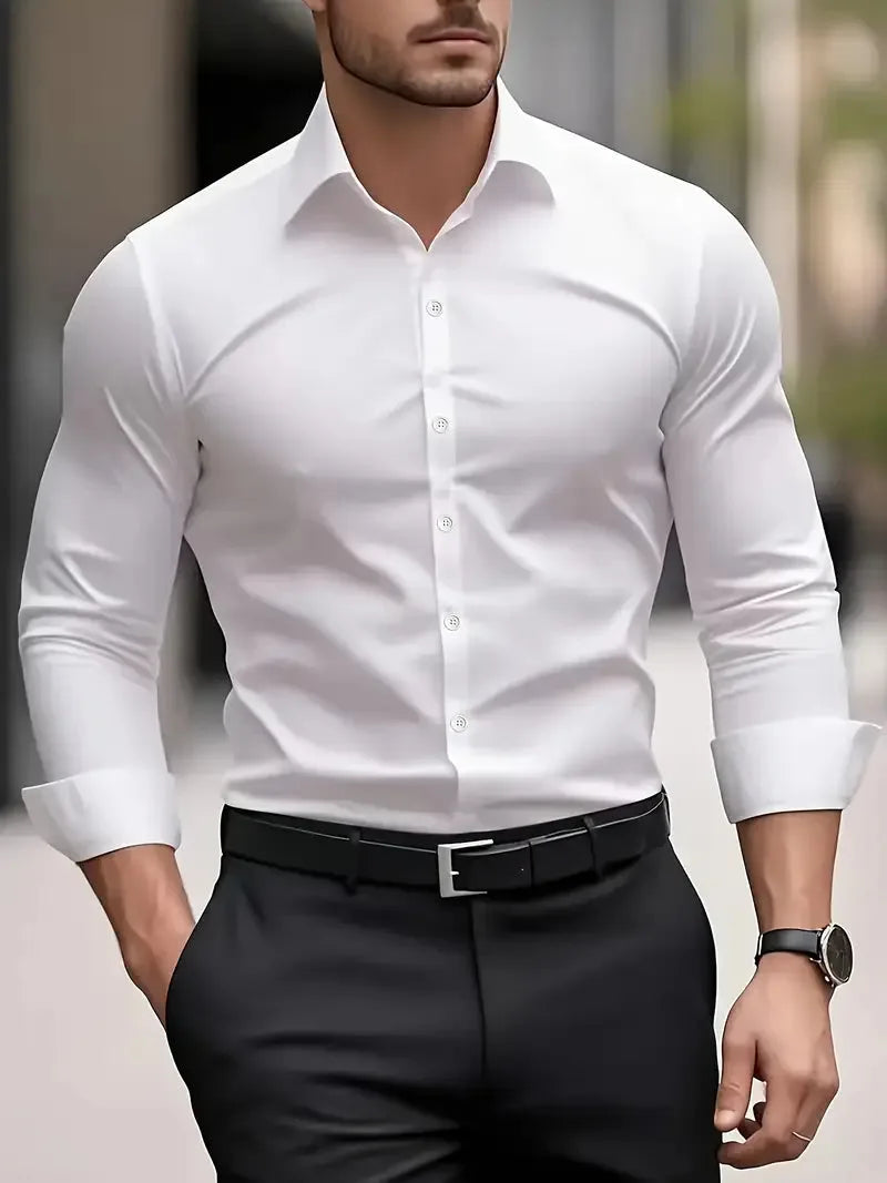 White long-sleeve button-down shirt shown from the front on a city street, collar open at the neck with top button undone