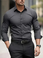 Dark grey long-sleeve button-down shirt with tonal buttons, worn fitted with a black belt and wristwatch
