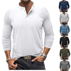 Front view of a man wearing a white long-sleeve henley with a three-button placket and stand collar, paired with dark jeans
