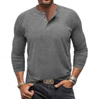 Close-up of the military green henley worn by a model, showing the relaxed fit through the torso