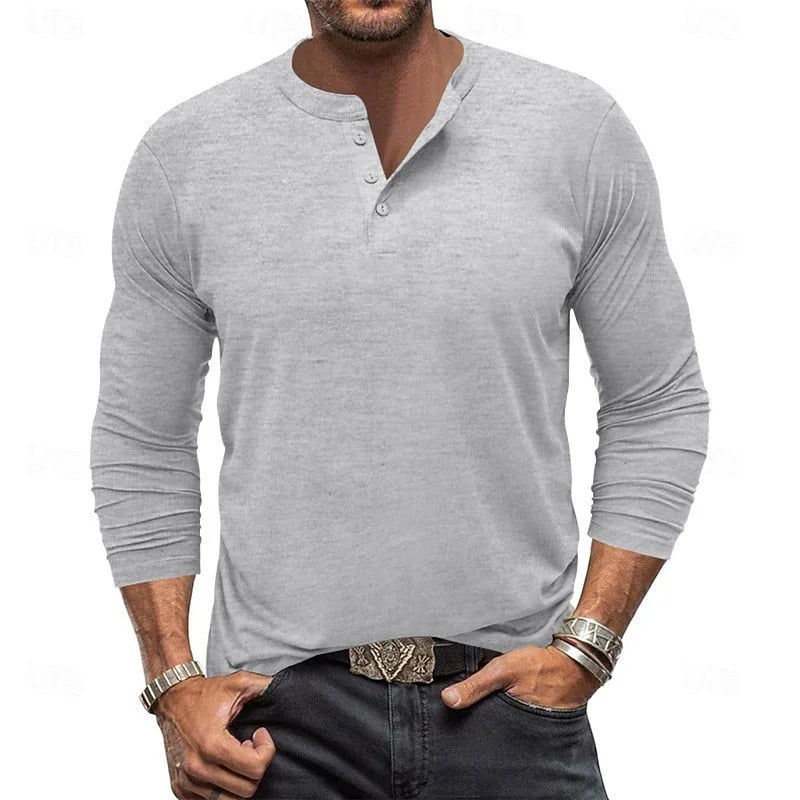 Front view of a man wearing a light grey long-sleeve henley with buttoned placket, styled with dark jeans and a belt