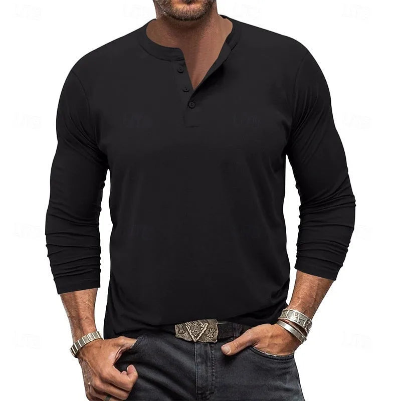 Front view of a man wearing a black long-sleeve henley with buttoned collar, paired with dark jeans