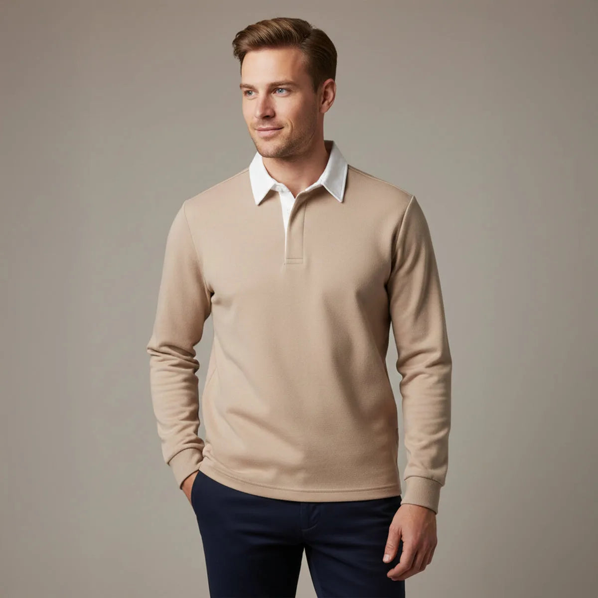 Man wearing a khaki long sleeve polo jumper with white collar, paired with navy trousers, shown from the front