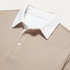 Close-up of the white contrast collar and button placket detail on the khaki knit polo jumper