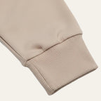 Close-up of the ribbed cuff on the sleeve of the khaki knit polo jumper
