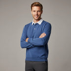 Man wearing a denim blue long sleeve polo jumper with white collar, arms crossed, shown from the front