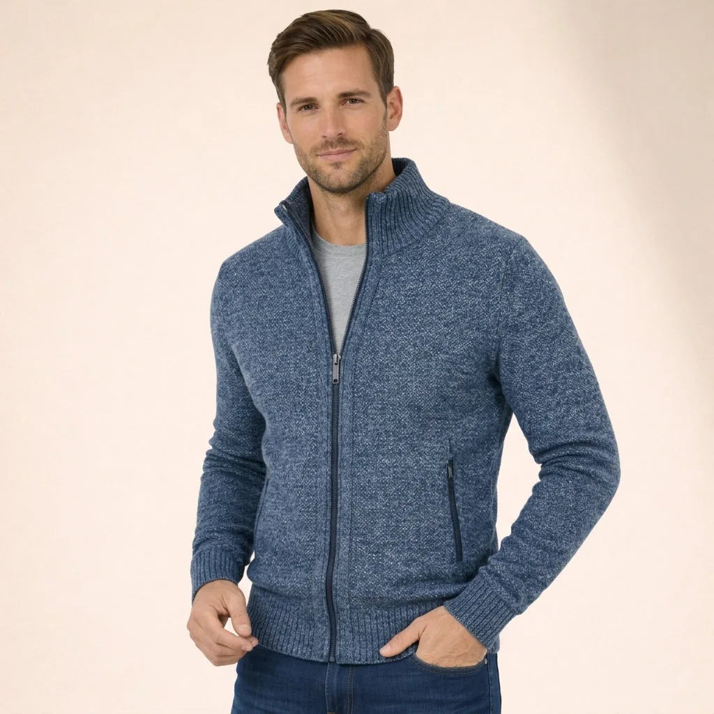 Man wearing a denim blue marl full-zip knitted jumper with ribbed stand collar and grey t-shirt underneath