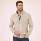 Side angle of the cream marl zip cardigan with hands tucked into jean pockets