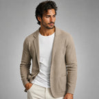 Beige knitted blazer cardigan on a hanger, front view showing long sleeves and relaxed tailored silhouette