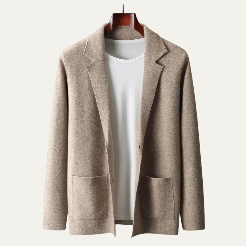Close view of a beige knitted suit-collar cardigan on a hanger, highlighting the tailored lapel and button front
