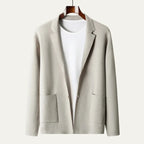 Light grey knitted blazer cardigan on a wooden hanger, showing the soft collar and two front patch pockets