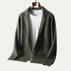 Beige knitted cardigan blazer laid flat showing both patch pockets and the ribbed cuff detail
