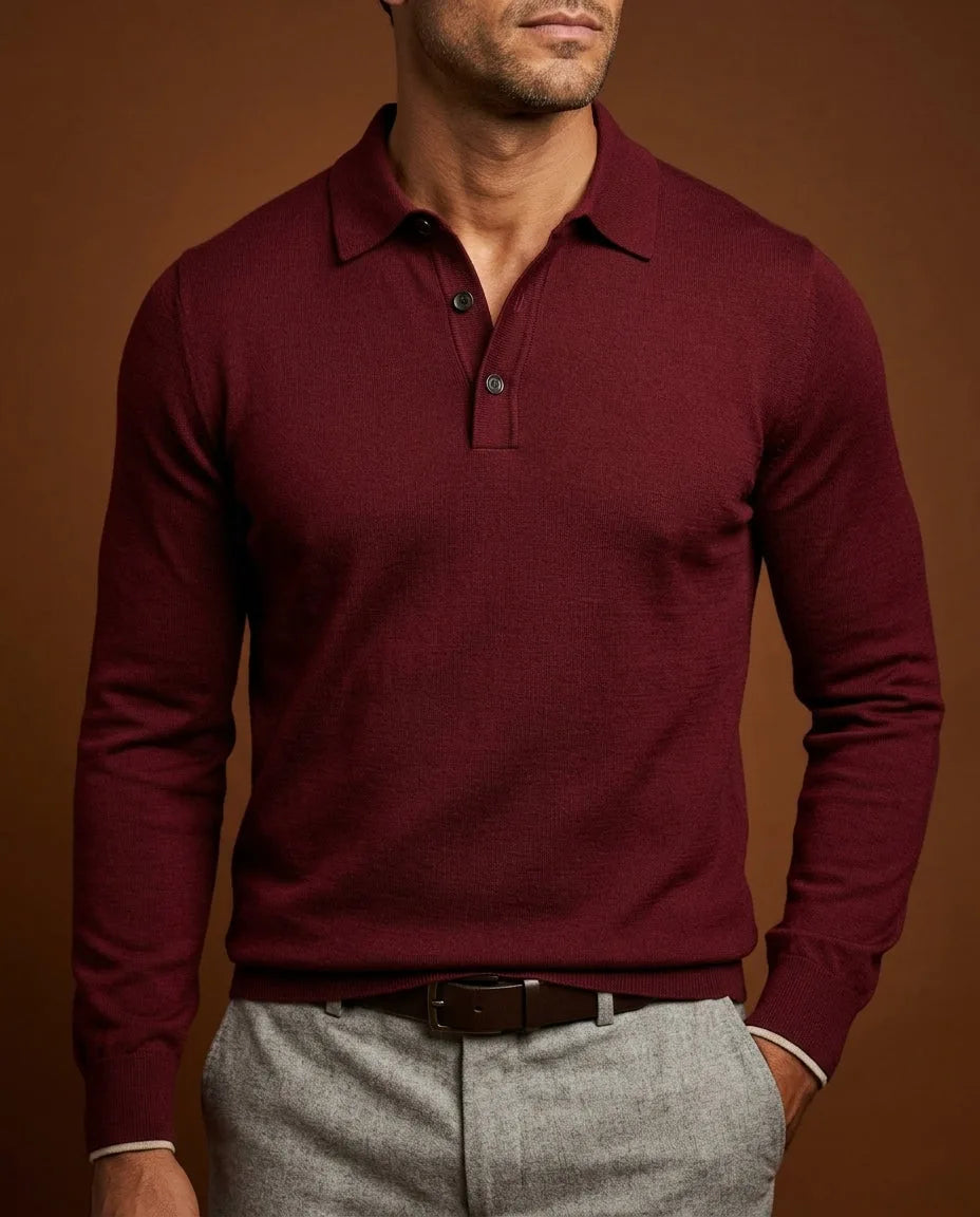 Wine red merino wool long-sleeve polo jumper paired with a brown leather belt and grey wool trousers